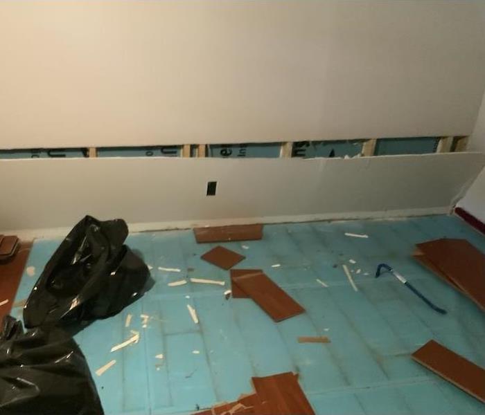 room with flooring floating in water on the kitchen floor