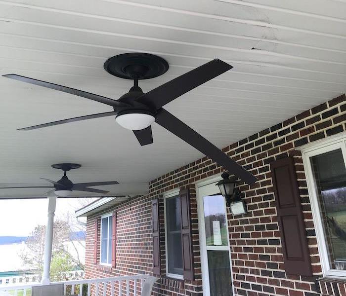 Broken fan with water stained ceiling