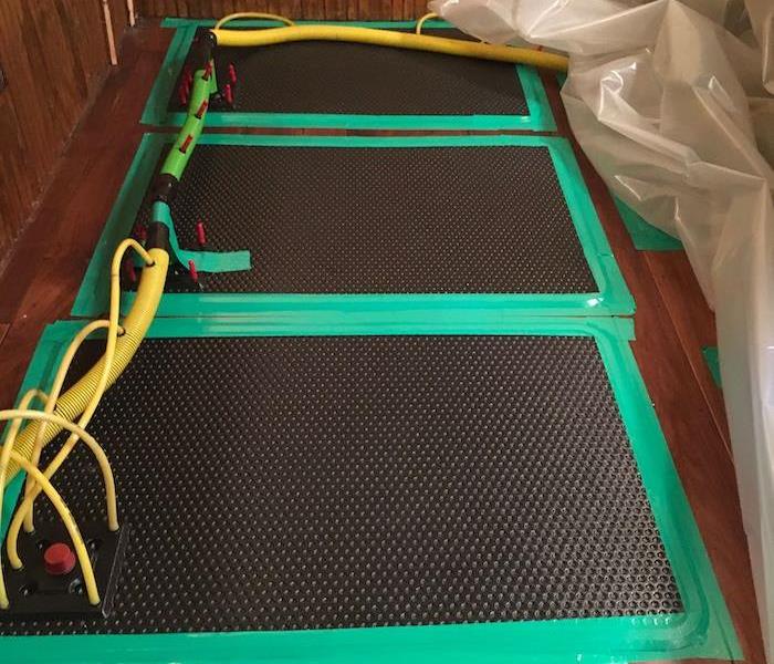 SERVPRO drying mats on wood floor