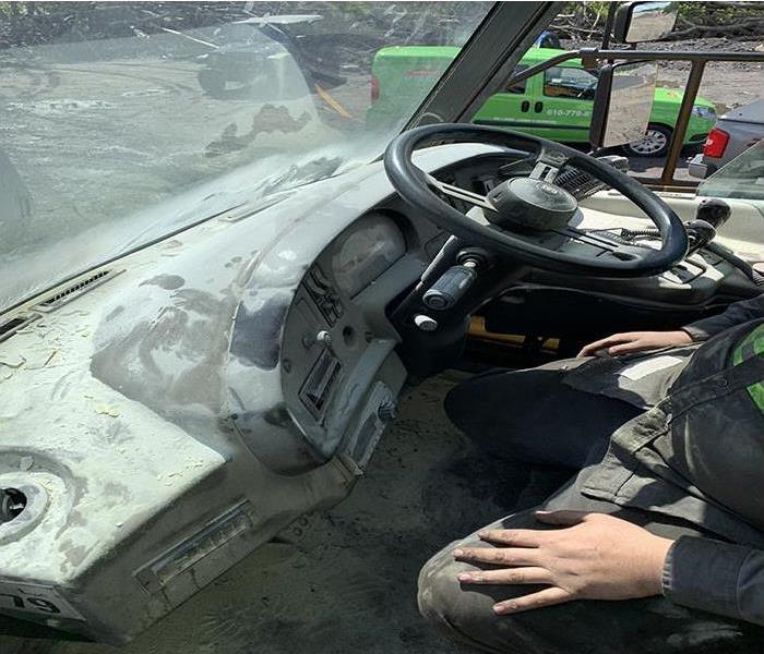 SERVPRO technician in a vehicle with extinguisher residue on the dash