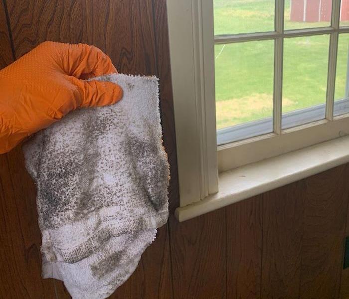 SERVPRO tech holding cloth with smoke damage residue