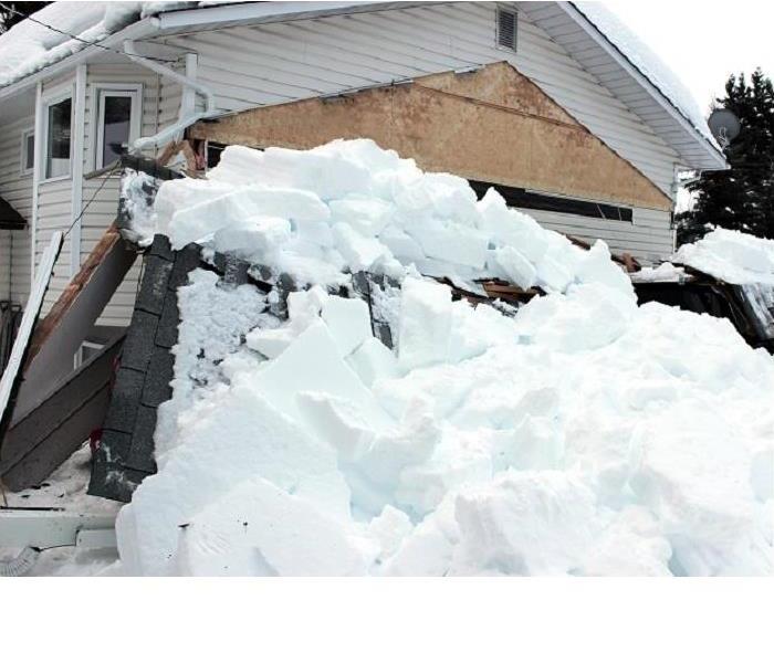 snow piled up next to home