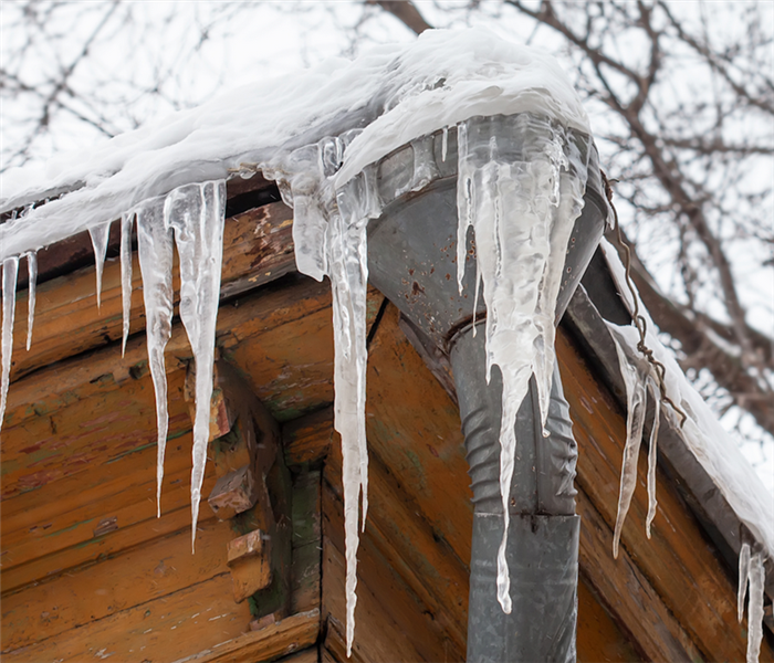 icicles hanging off of the gutters of a house