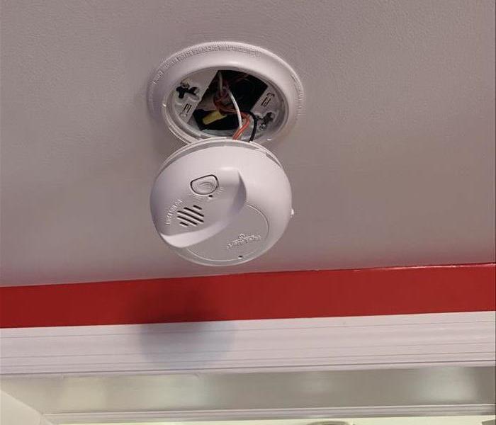 smoke detector opened on a ceiling