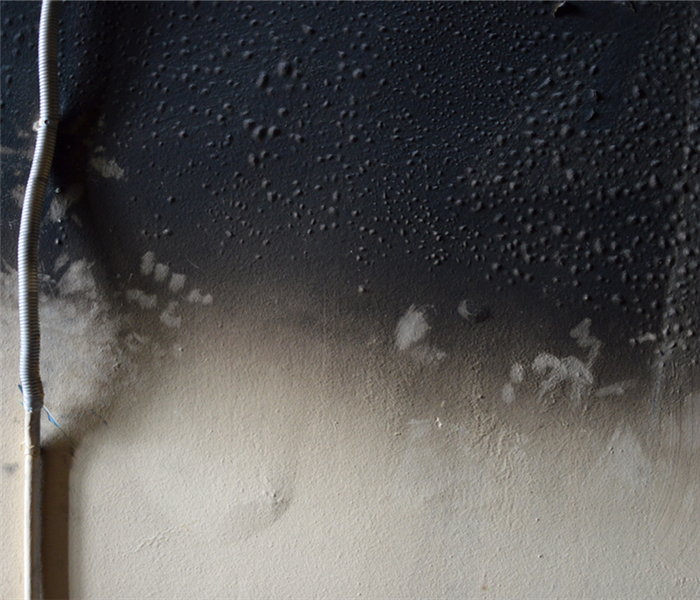 a soot covered wall from fire damage